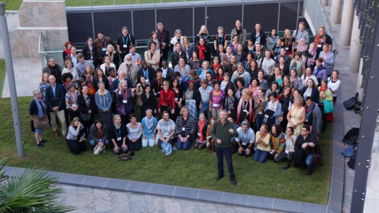 group of conference attendees posing for group photo taken from above